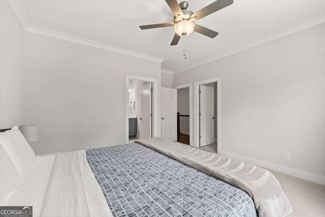 carpeted bedroom featuring baseboards, ornamental molding, ceiling fan, and connected bathroom