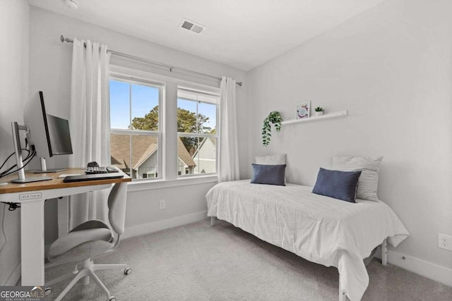 carpeted bedroom featuring visible vents and baseboards