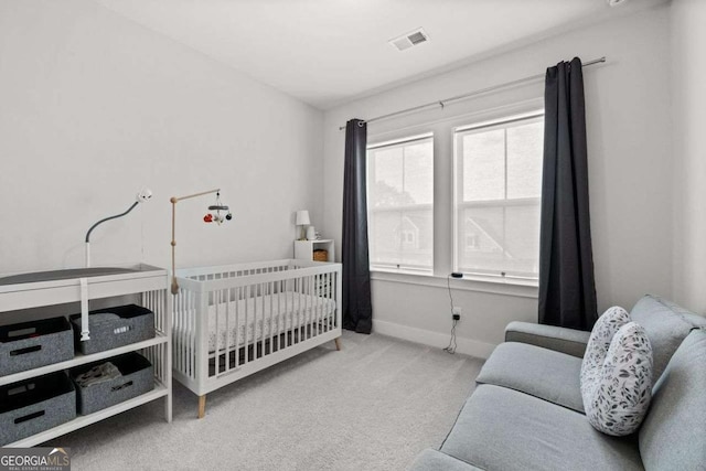 carpeted bedroom featuring visible vents and baseboards