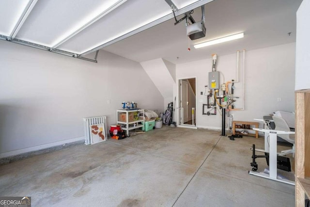 garage featuring a garage door opener, tankless water heater, and baseboards