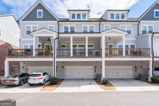 view of front of property featuring driveway, an attached garage, central AC, and board and batten siding