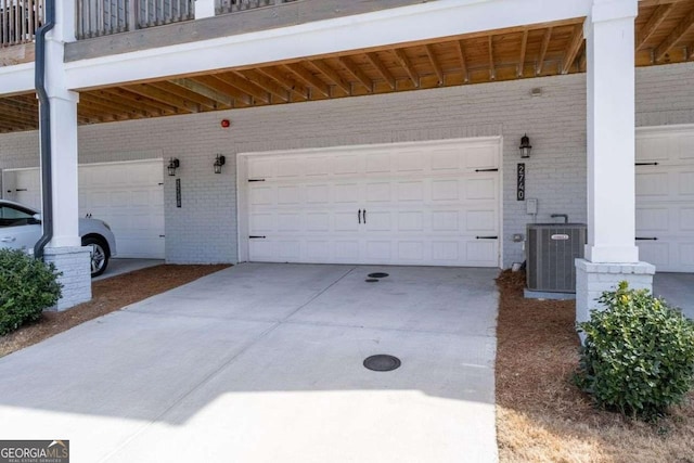 garage featuring driveway and central AC unit