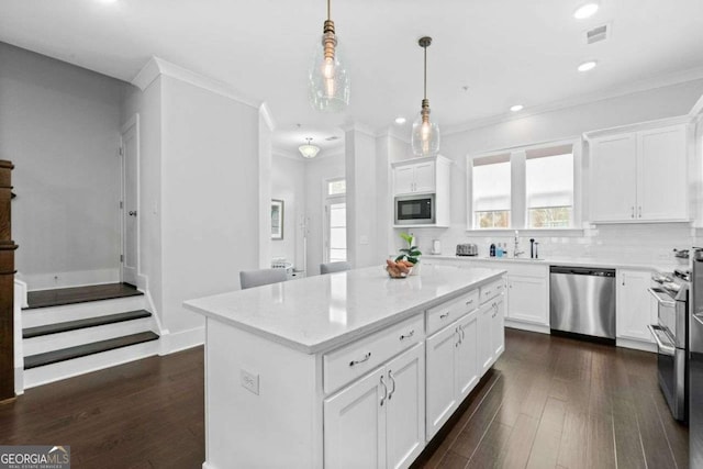 kitchen featuring dishwasher, dark wood finished floors, visible vents, and built in microwave