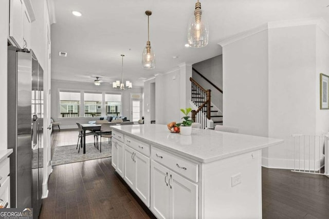 kitchen featuring radiator, ornamental molding, dark wood-style flooring, freestanding refrigerator, and white cabinetry