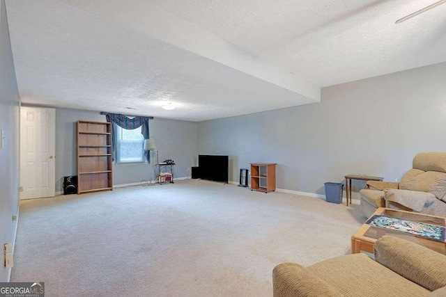 living area with baseboards, a textured ceiling, and light colored carpet