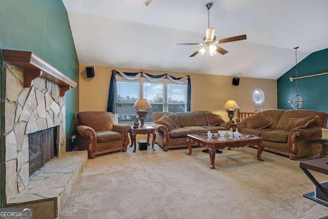 carpeted living area with lofted ceiling, a stone fireplace, and a ceiling fan