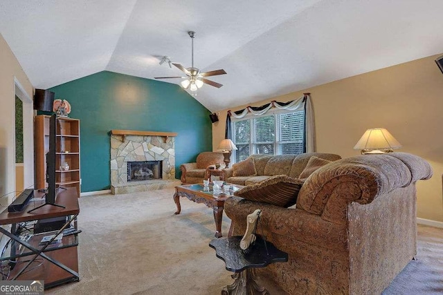 living room featuring baseboards, ceiling fan, vaulted ceiling, carpet flooring, and a fireplace