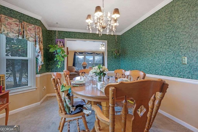 carpeted dining room with crown molding, ceiling fan with notable chandelier, baseboards, and wallpapered walls