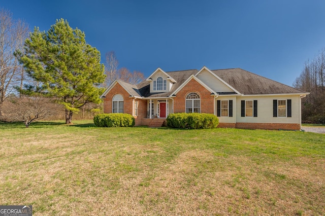 view of front of house featuring a front yard and brick siding