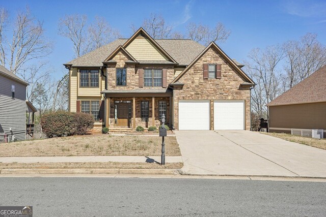 craftsman-style house featuring an attached garage, concrete driveway, and roof with shingles