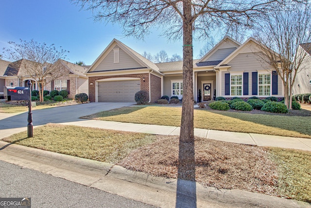 view of front of property featuring driveway, an attached garage, a front lawn, and brick siding