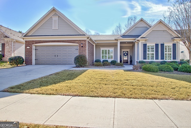 view of front of house featuring a garage, driveway, brick siding, and a front yard