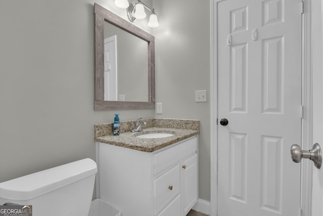 bathroom featuring vanity and toilet