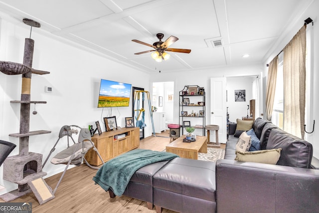 living area with visible vents, ceiling fan, and light wood finished floors