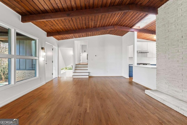 unfurnished living room featuring wood finished floors, wooden ceiling, vaulted ceiling with beams, and stairs