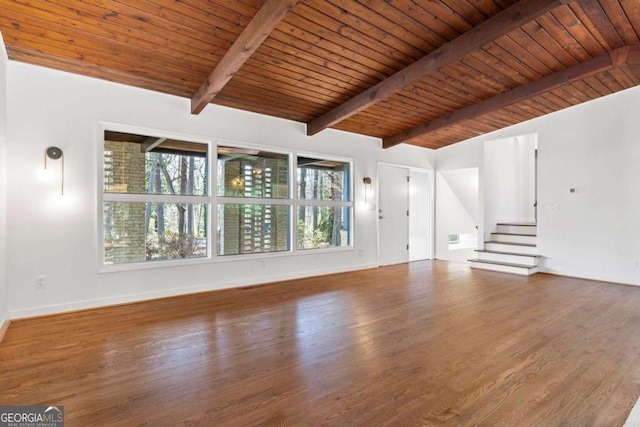 unfurnished living room featuring vaulted ceiling with beams, wood finished floors, wood ceiling, baseboards, and stairs