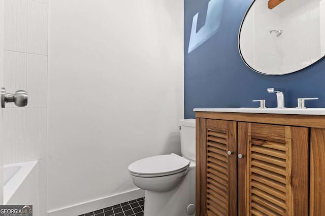 bathroom with baseboards, vanity, toilet, and tile patterned floors