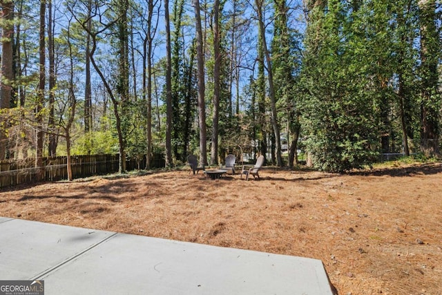 view of yard featuring a fire pit and fence