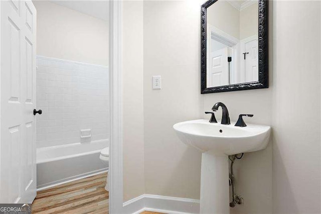 full bathroom with a tub to relax in, walk in shower, wood finished floors, and baseboards