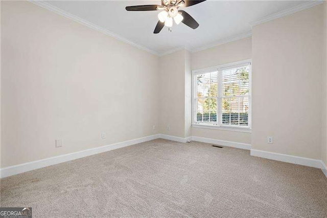 spare room featuring crown molding, light colored carpet, visible vents, ceiling fan, and baseboards