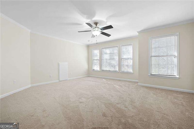 empty room featuring baseboards, ornamental molding, and carpet flooring
