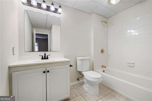 bathroom with shower / bath combination, toilet, vanity, tile patterned flooring, and baseboards