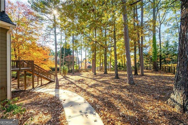 view of yard featuring fence and stairway