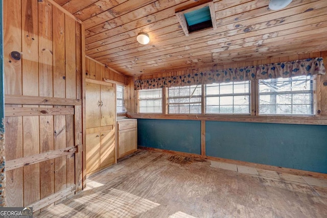 spare room featuring wood ceiling and a healthy amount of sunlight