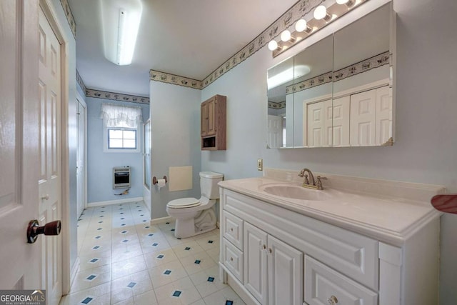 full bath featuring toilet, vanity, baseboards,  shower combination, and heating unit