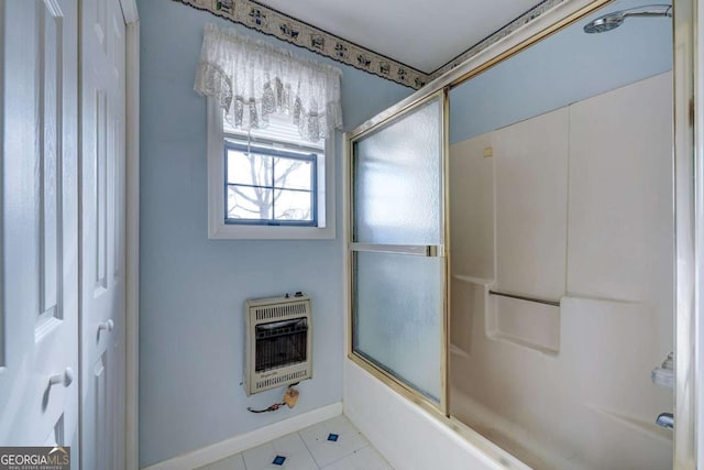 full bathroom with baseboards, shower / bath combination with glass door, and heating unit