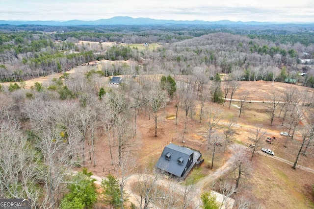 bird's eye view featuring a forest view and a mountain view