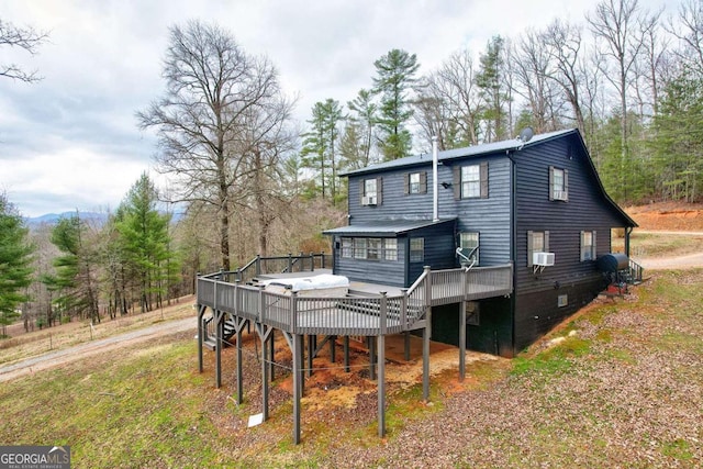 rear view of property with cooling unit and a deck