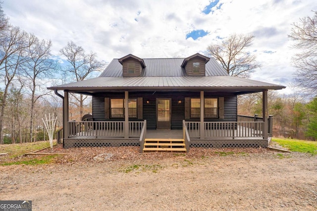 rustic home featuring covered porch and metal roof