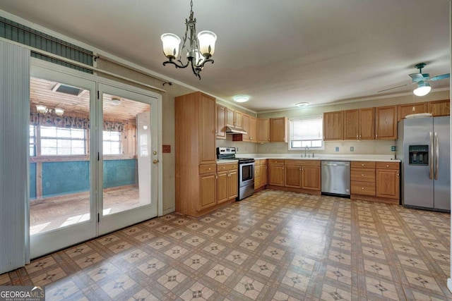 kitchen with light floors, appliances with stainless steel finishes, light countertops, and a sink