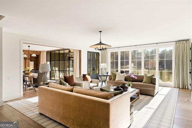 living area featuring a chandelier and light wood-type flooring