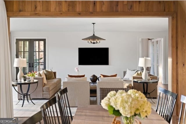 living area with french doors and beamed ceiling