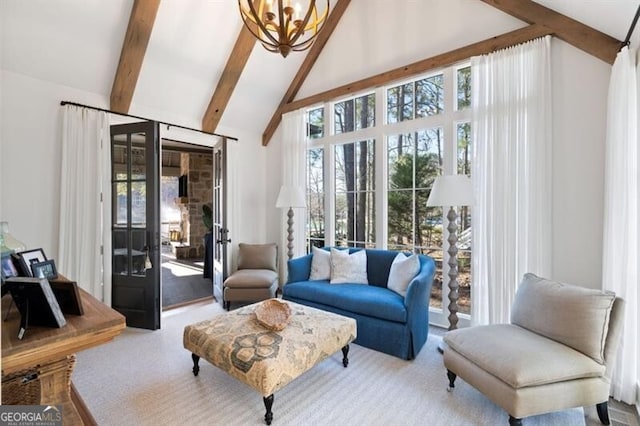 interior space featuring beam ceiling, high vaulted ceiling, an inviting chandelier, and carpet floors