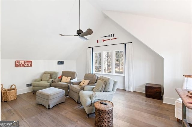 interior space with wood finished floors, visible vents, baseboards, lofted ceiling, and ceiling fan