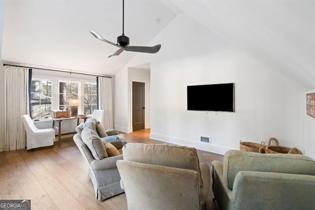 living room with visible vents, baseboards, ceiling fan, light wood-type flooring, and high vaulted ceiling