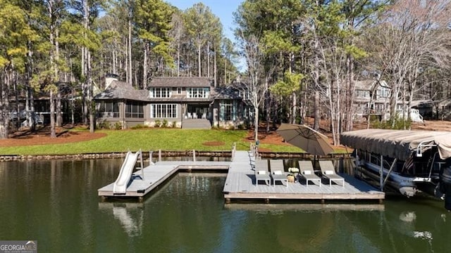 view of dock featuring a yard and a water view