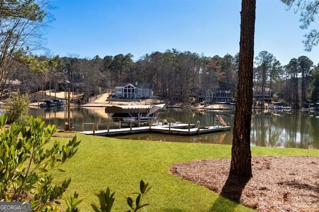 dock area with a yard and a water view