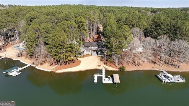 drone / aerial view featuring a view of trees and a water view