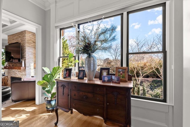 office space featuring light wood-type flooring and ornamental molding