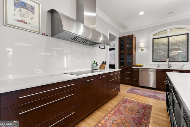 kitchen featuring wall chimney range hood, dishwasher, light countertops, modern cabinets, and black electric cooktop