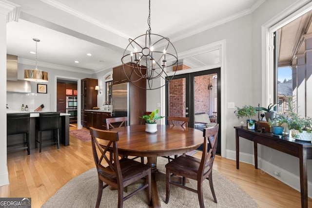 dining area with french doors, baseboards, crown molding, and light wood finished floors