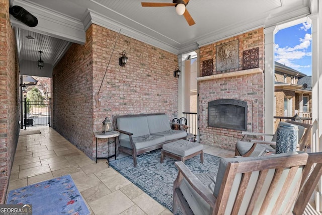 view of patio with an outdoor living space with a fireplace and ceiling fan