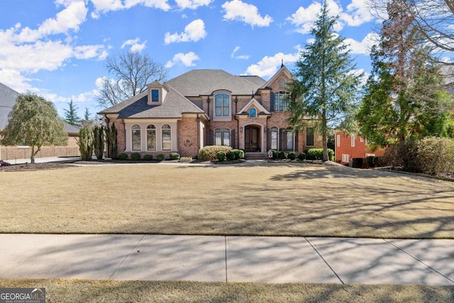 french provincial home with brick siding