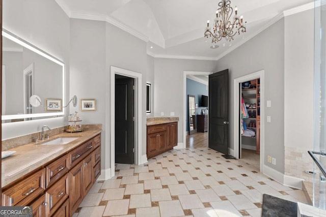 full bath with crown molding, baseboards, a chandelier, lofted ceiling, and vanity