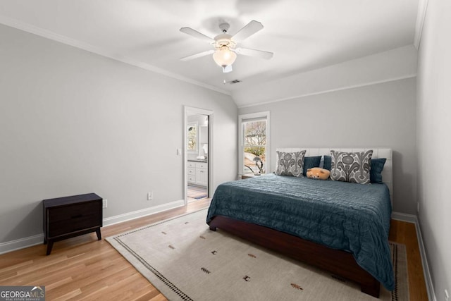 bedroom with light wood-type flooring, baseboards, visible vents, and vaulted ceiling