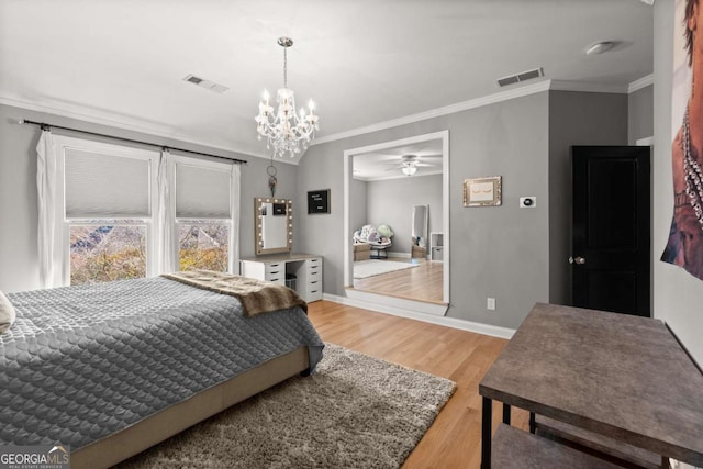 bedroom featuring light wood-type flooring, visible vents, baseboards, and ornamental molding